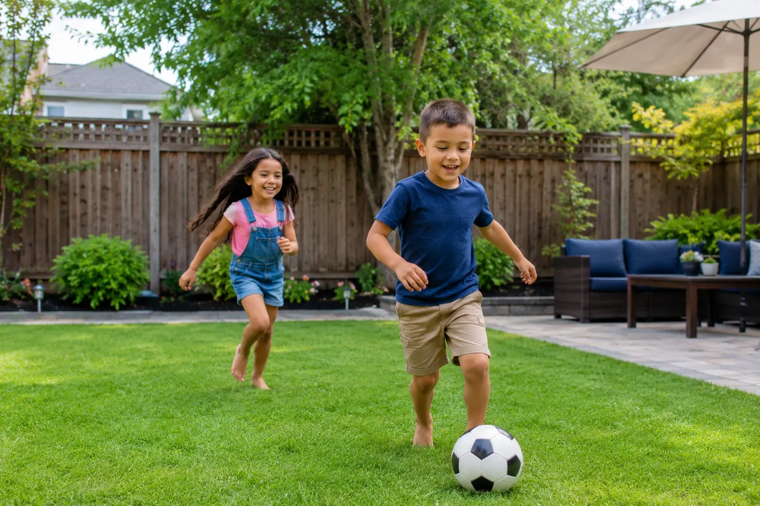 Two children playing soccer barefoot in a sanitized, parasite-free Seattle backyard maintained by Humane Paws pet waste removal service.